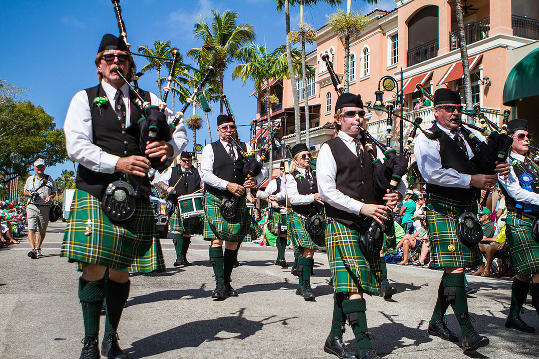 people play bagpipes during the parade